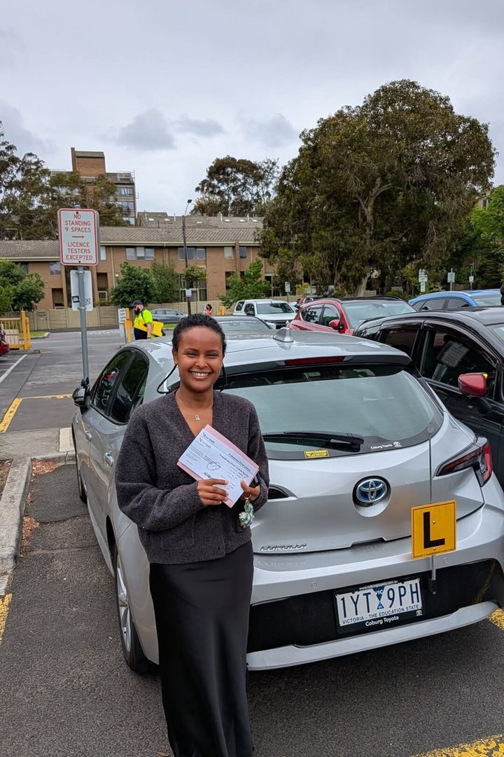 Student celebrating driving test pass Melbourne