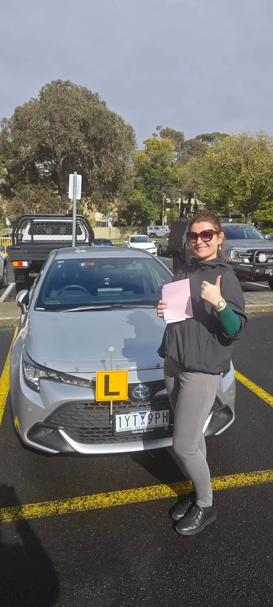 Student thumbs up after passing driving test