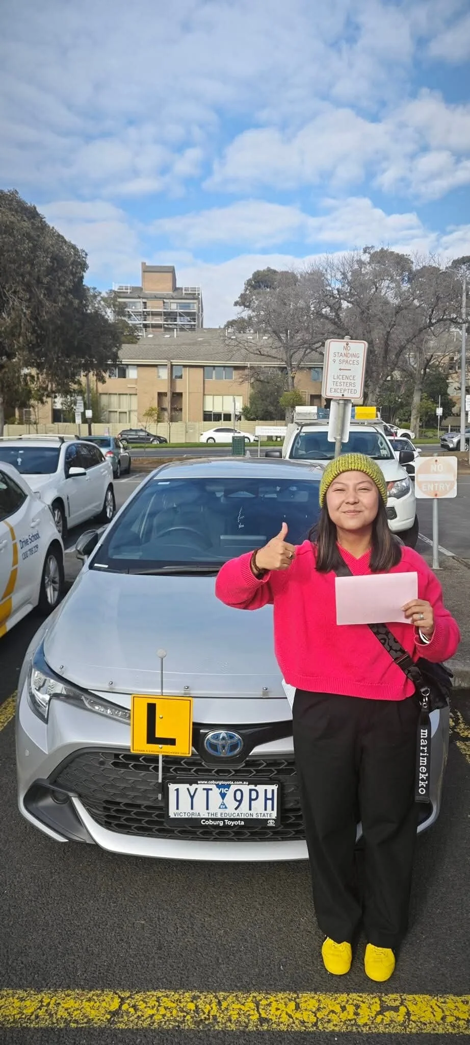 Happy overseas licence holder gives thumbs up after passing VicRoads test — Freshers Driving School