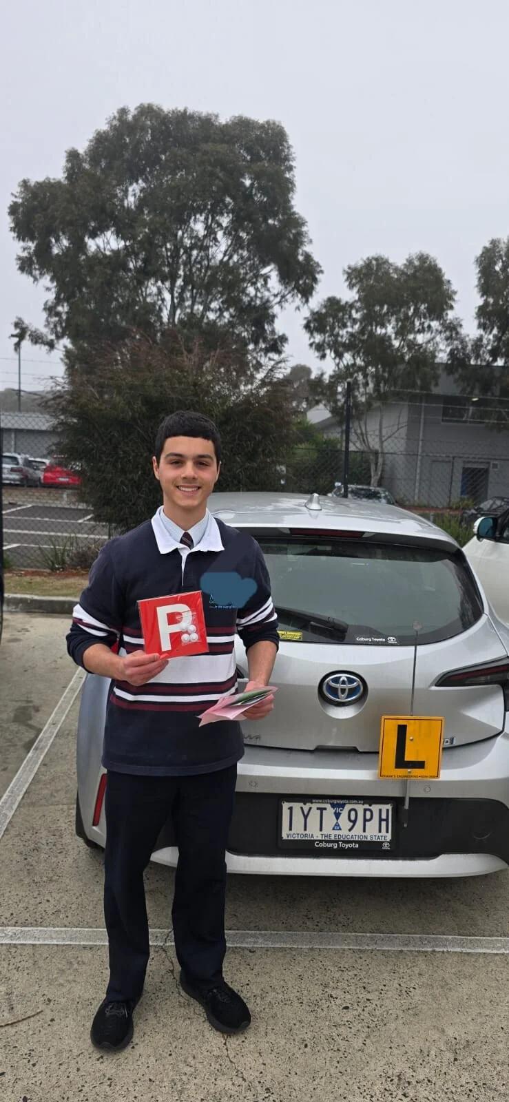 Student holds P plates after passing VicRoads drive test with Freshers Driving School Melbourne